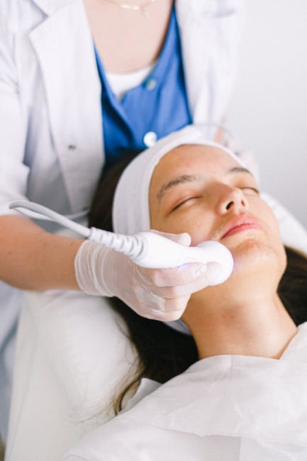 pexels photo 5069423 5069423 Professional female cosmetologist wearing medical uniform doing ultrasonic face cleaning for relaxed young female customer in modern beauty clinic